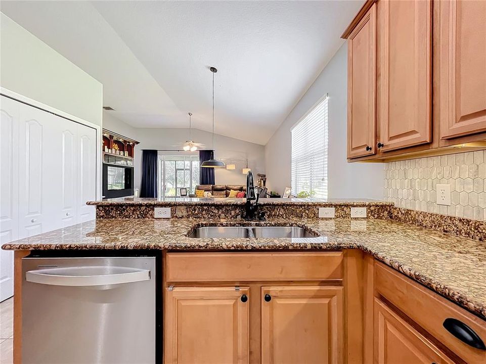 Kitchen looking into eat in area and living room