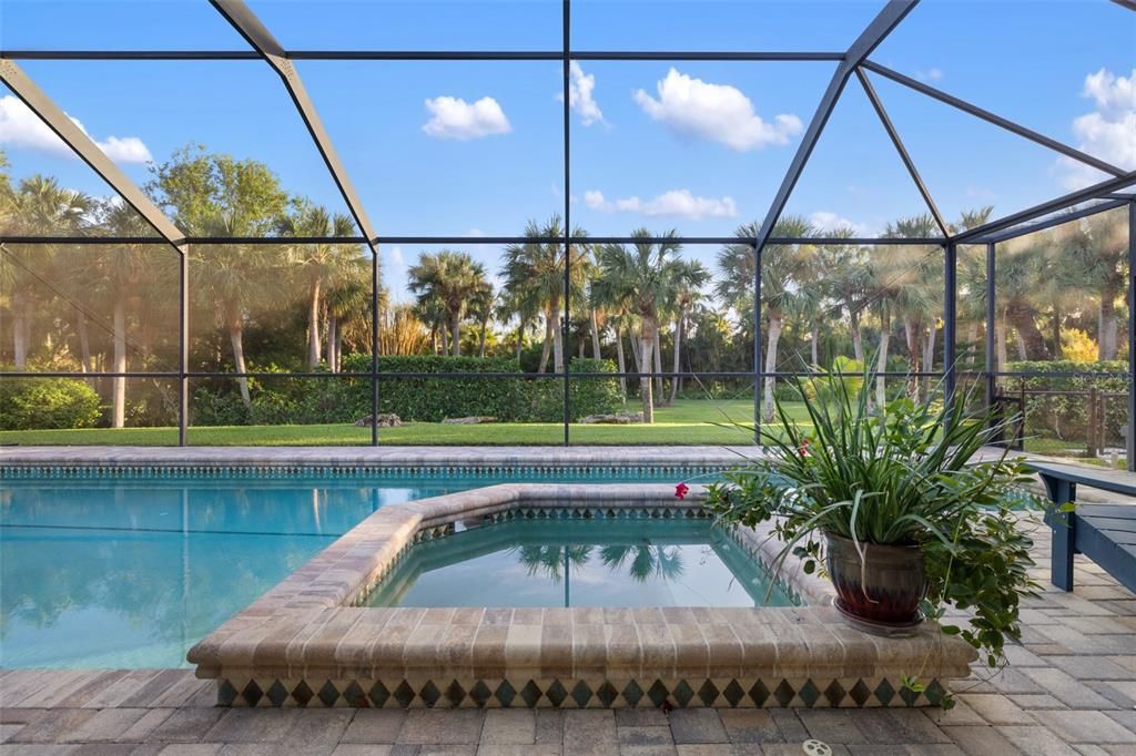 Spa with view of manicured lawn and landscape