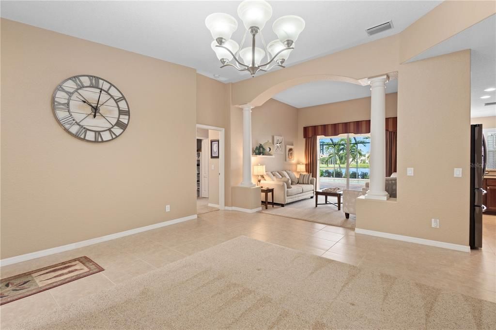 Foyer with view of dining or sitting area and living room