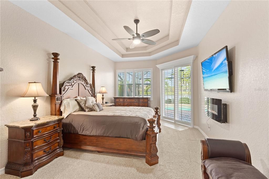 Owner's Suite with tray ceiling and sliders the lanai