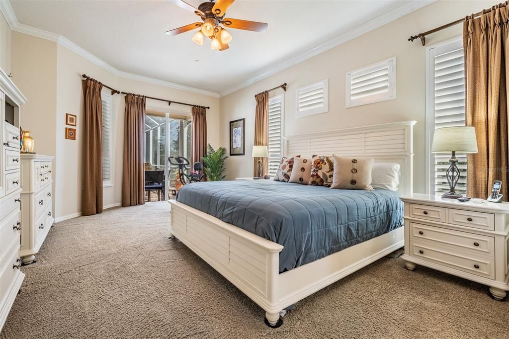 Super Large Primary Bedroom with Crown Molding, Plantation Shutters, Ceiling Fan with Light Fixture.