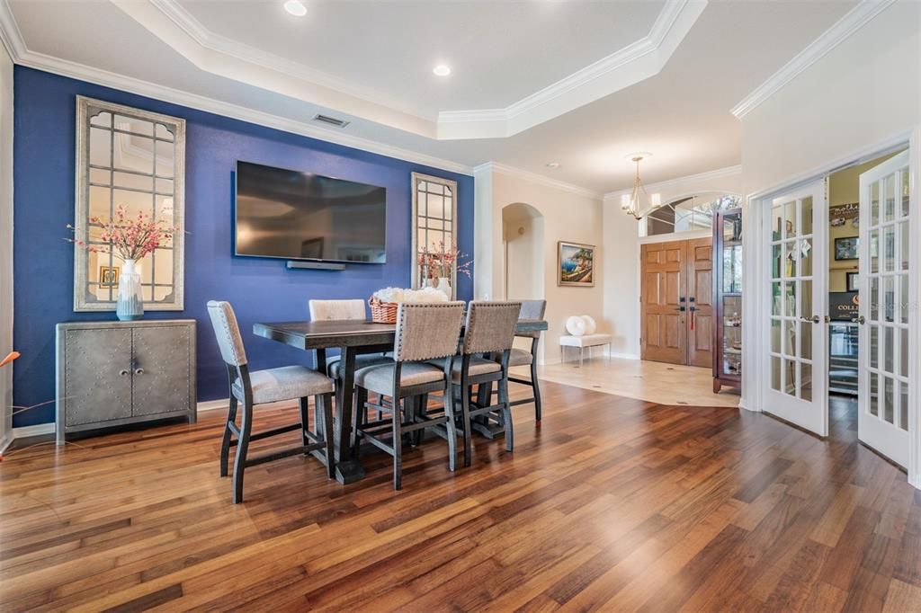 Large Dining Room with Burma Walnut Flooring, Inset Ceiling with Crown Molding, Office is on the right with the French Doors.