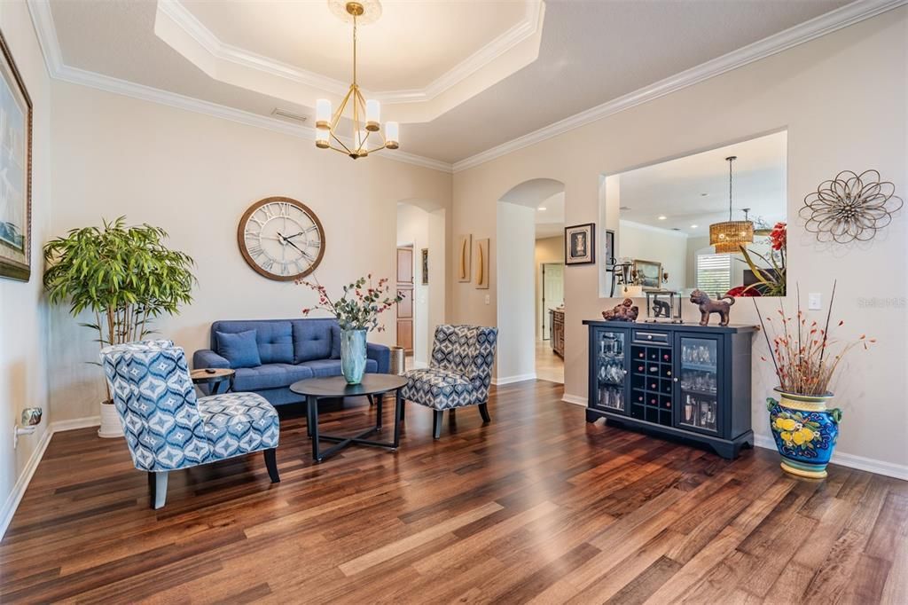 Living Room with Inset Ceiling, Crown Molding, Burma Walnut Flooring.