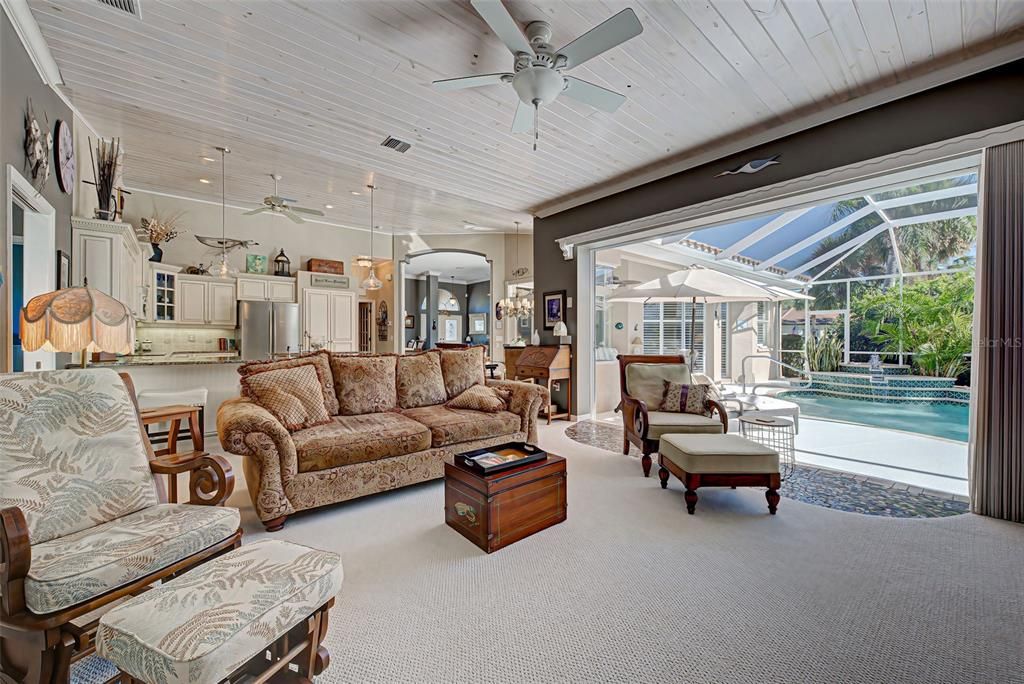 Spacious family room has lanai pocket doors which open fully, making lanai access so easy.