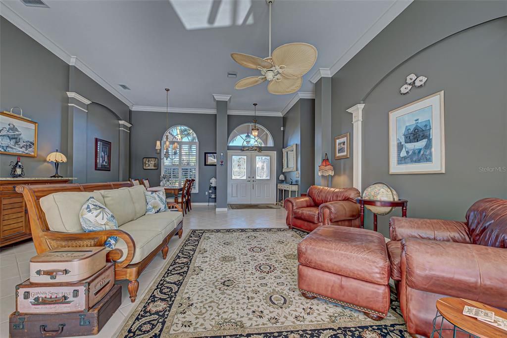 Another view of living room with new fans, fresh interior paint and classy architectural details.