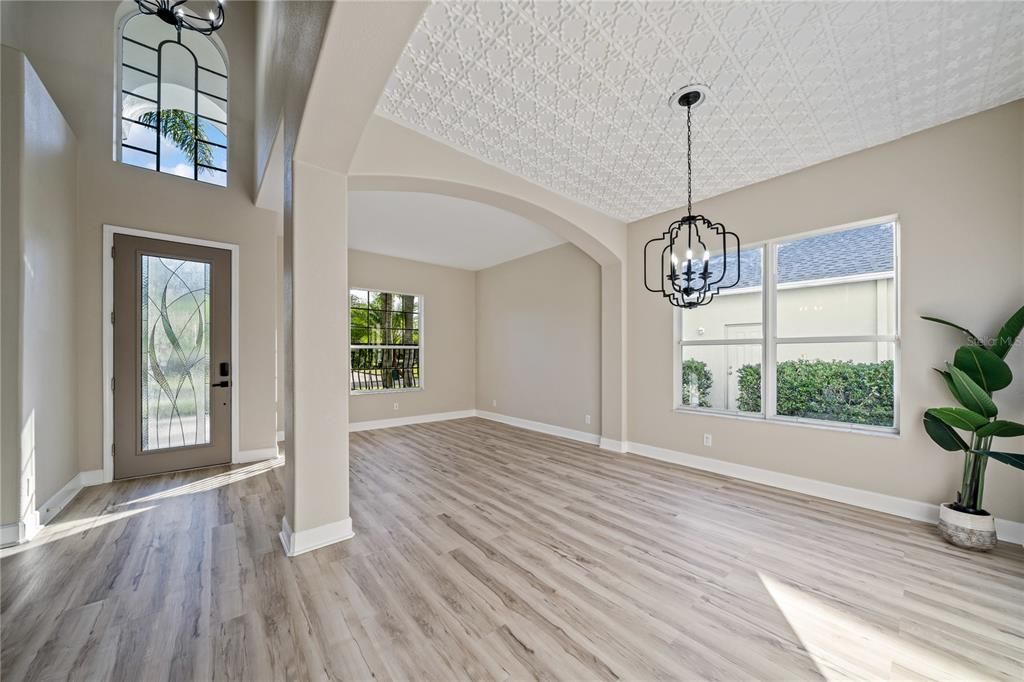 Formal living room and dining room with custom ceiling treatment