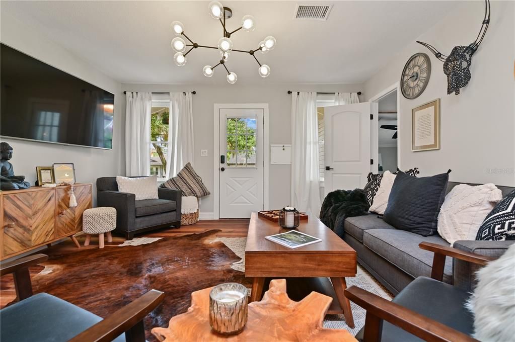 We put a lot of heart and soul into repurposing the original 100 year old sub flooring and re-installed it as the main floor. It adds so much character to this 1200 sq. ft. home. Master bedroom entry is to left of the couch near the front door.