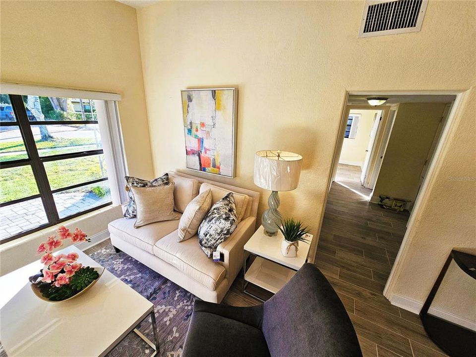 Living room with view of the front yard and the hallway