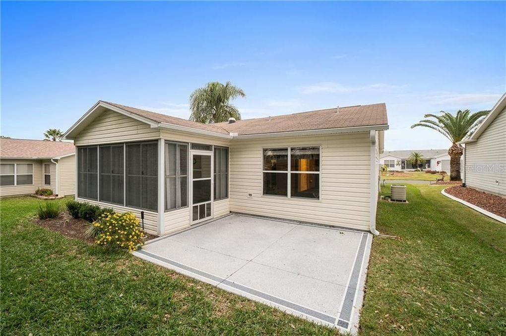 Rear view of home with concrete patio for grilling