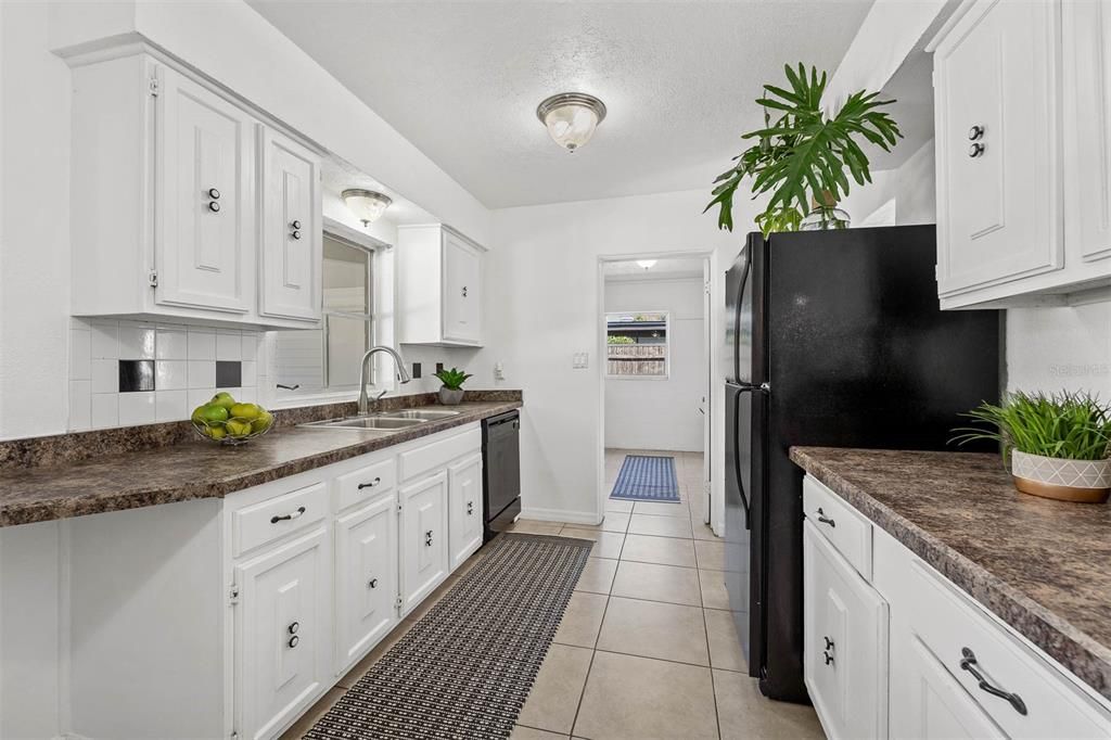 Kitchen and laundry room straight ahead