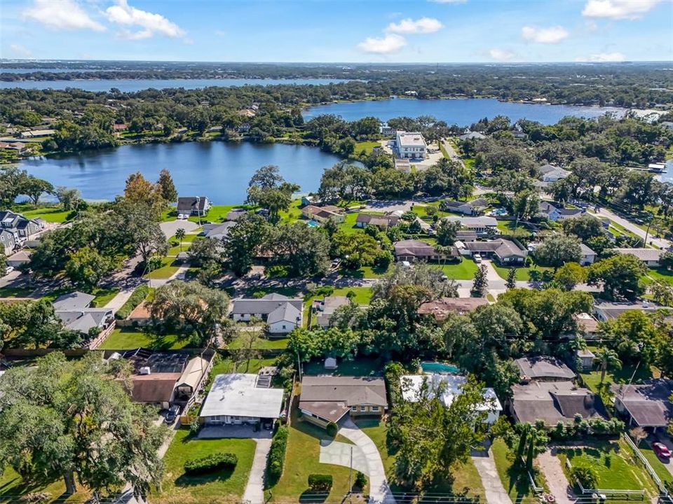 Drone photo - Home surrounded by lakes and is located at the bottom of the photo. Starting at bottom Lake Gem Mary, Lake Gatlin and Little Lake Conway.