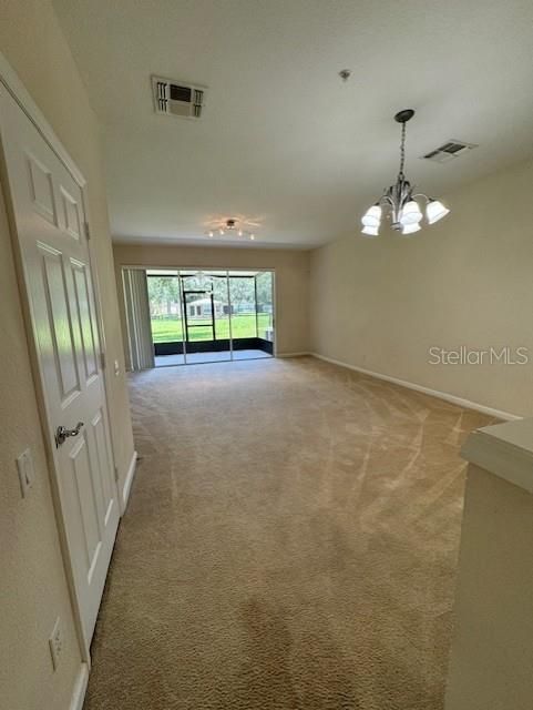 Features a seamless family room and dining room combo, adorned with a carpet flooring throughout.