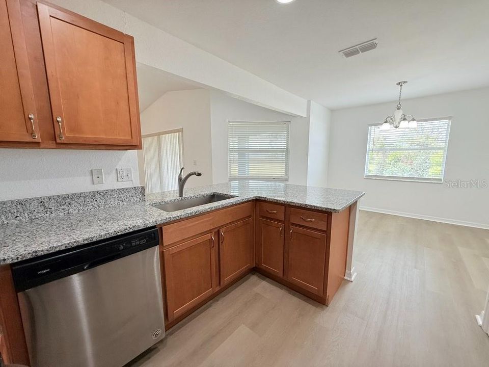 Layout of newly remodeled kitchen with large stainless steel sink.