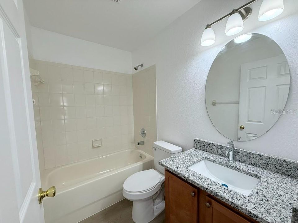 Guest Bathroom, new toilet and granite counter-tops with under-mount sink.