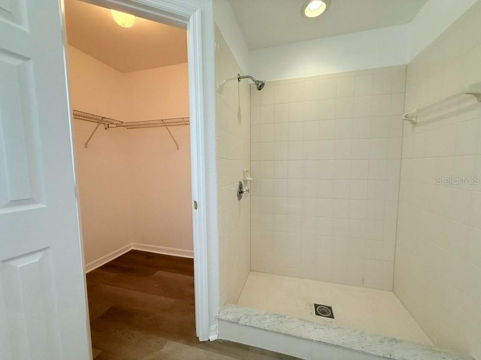 Walk-in shower in Primary Bath. 1 of 2 walk-in closets.