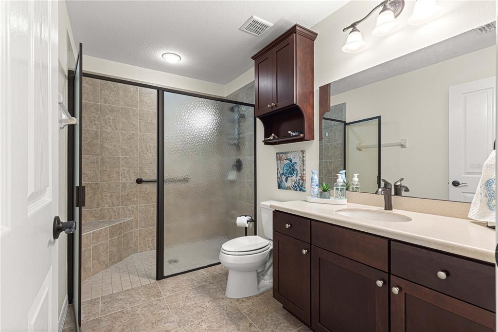 Handicapped Accessible second bathroom with sitting bench.