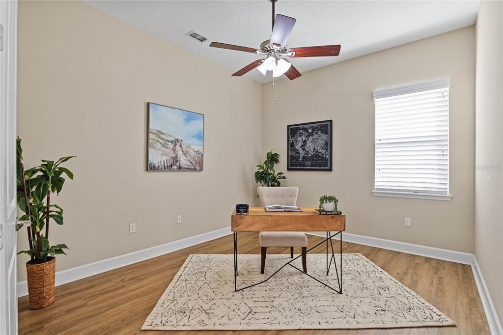 13'6" x 11' Den/Office w/ luxury vinyl floor, ceiling fan & a double door entry