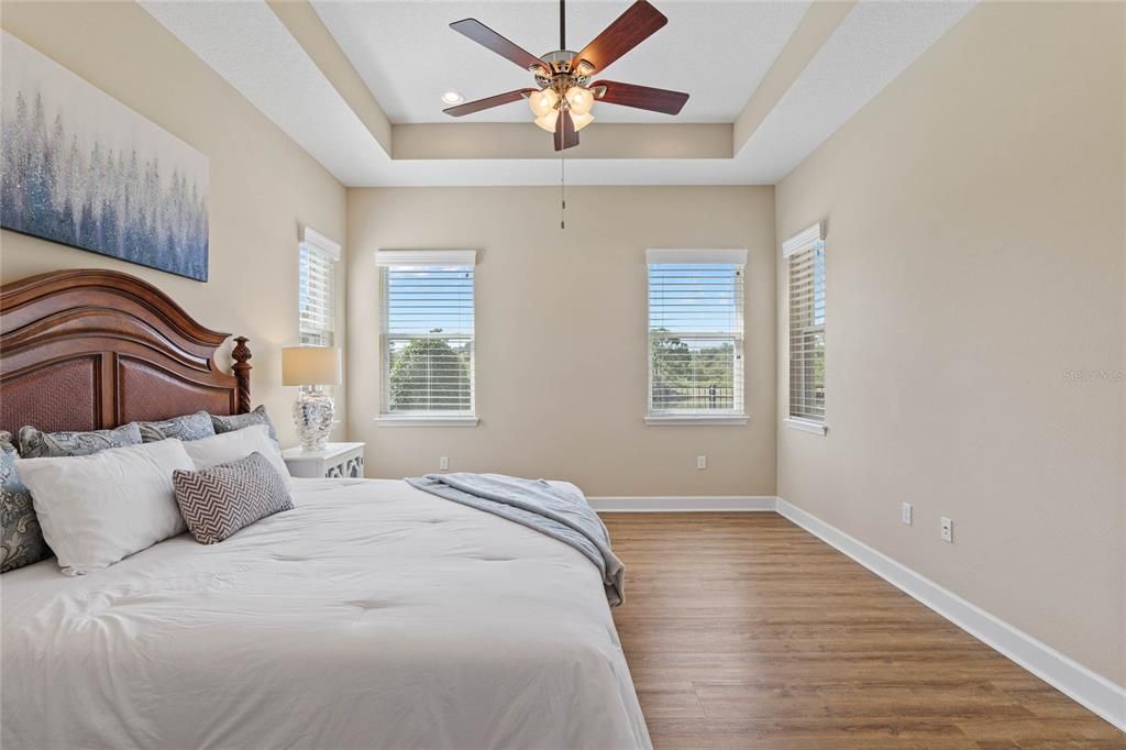 Primary Bedroom w/ multiple windows to overlook the pond & conservation area