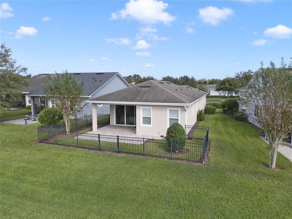 Aerial view of rear of home w/ fenced backyard