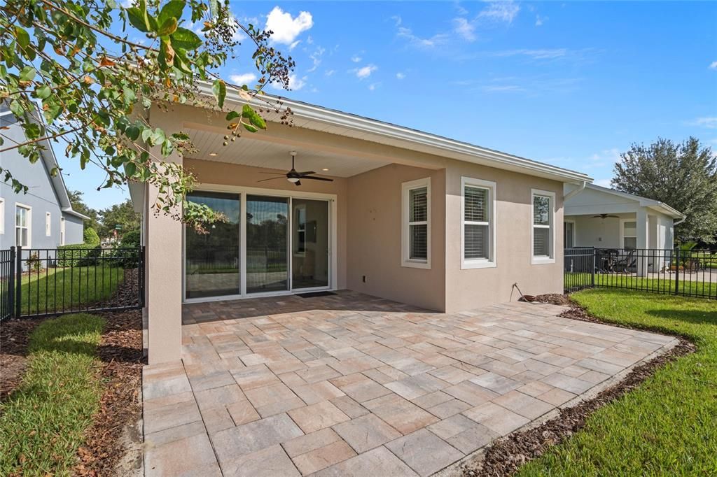 Rear view of home w/ fenced backyard