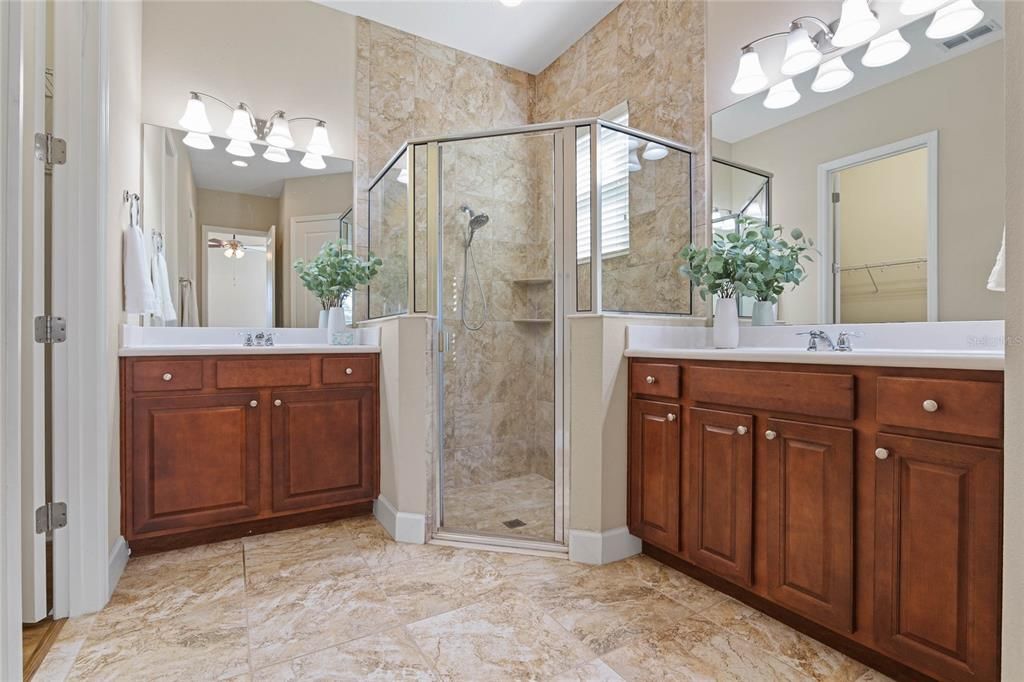 Primary Bath w/ double vanities, glass enclosed walk-in shower & corner bench seat