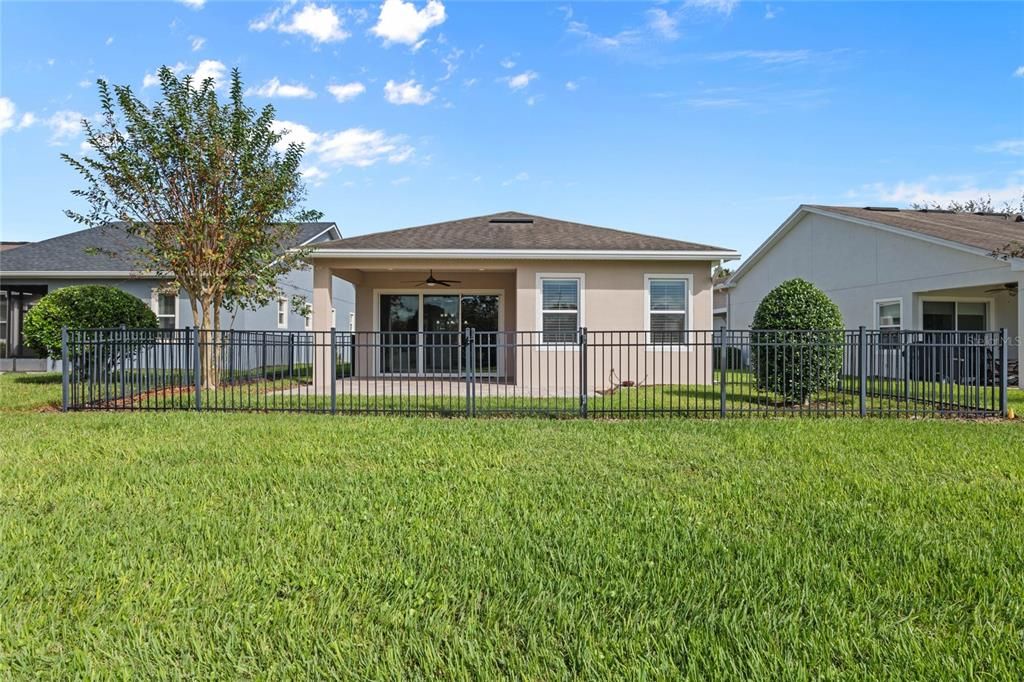 Rear view of home w/ fenced backyard