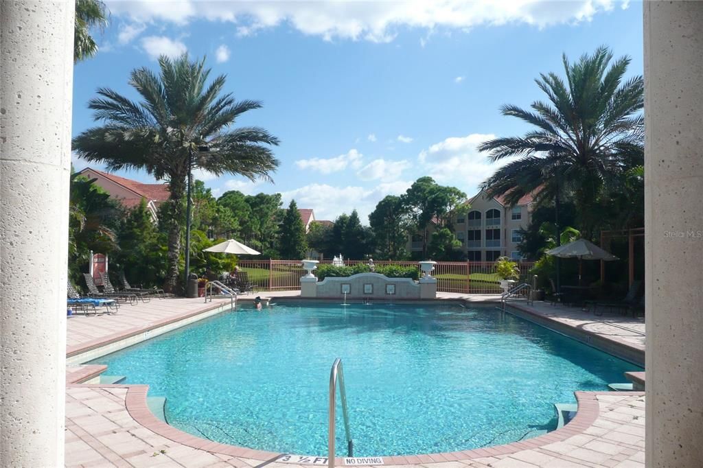 Pool with lake and fountain beyond.