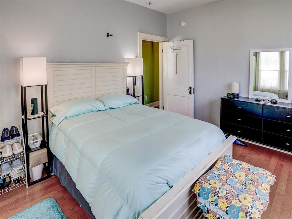 Primary bedroom downstairs with real wood floors.