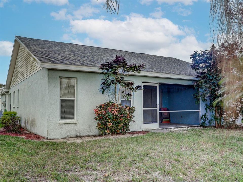 Back of the home with a screened lania.