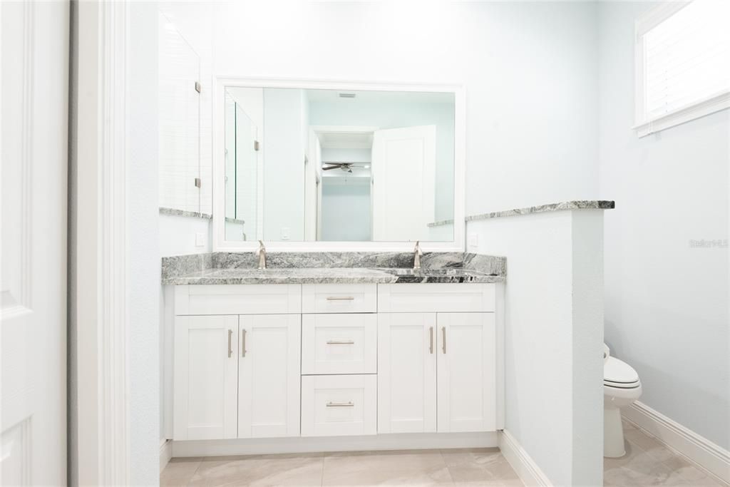 Master Bathroom with dual vanity sinks and glassed stand-in shower