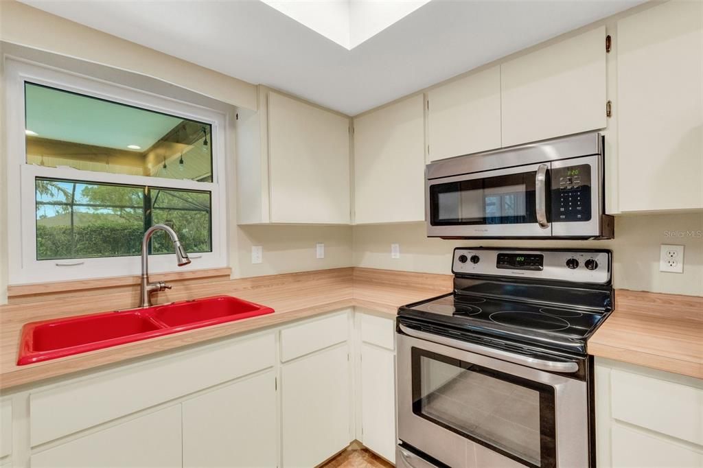 kitchen showing passthrough window to patio for entertainment ease