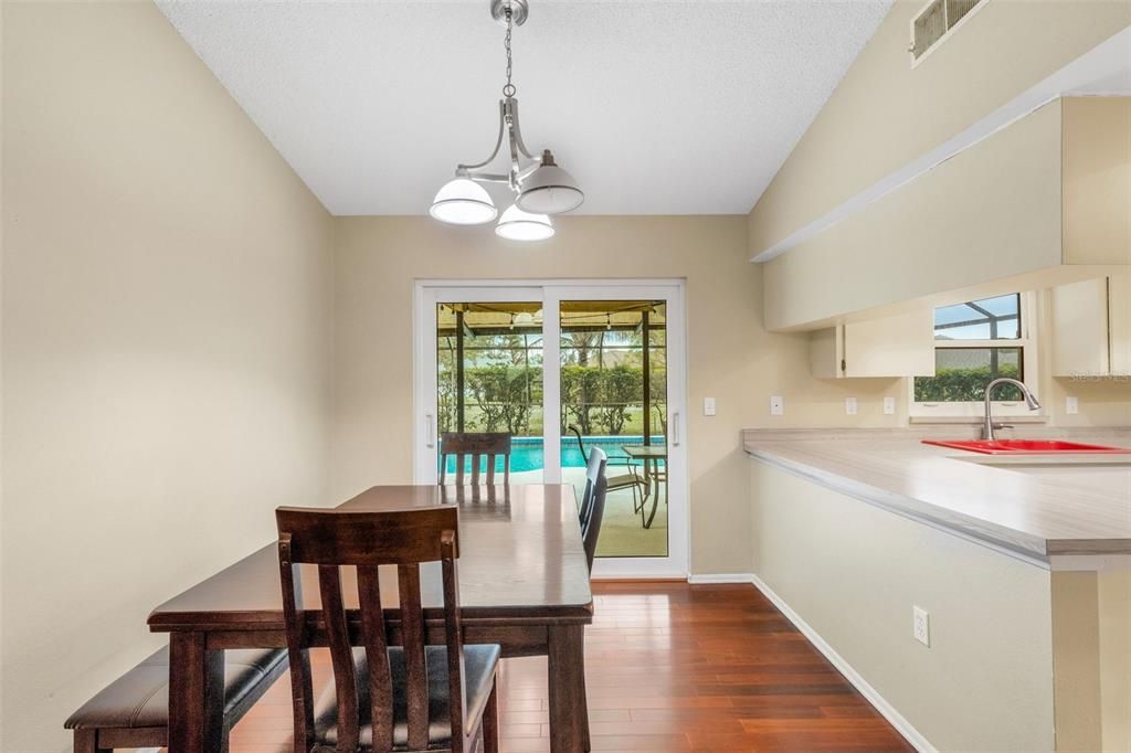 dining room with impact slider to patio/pool area