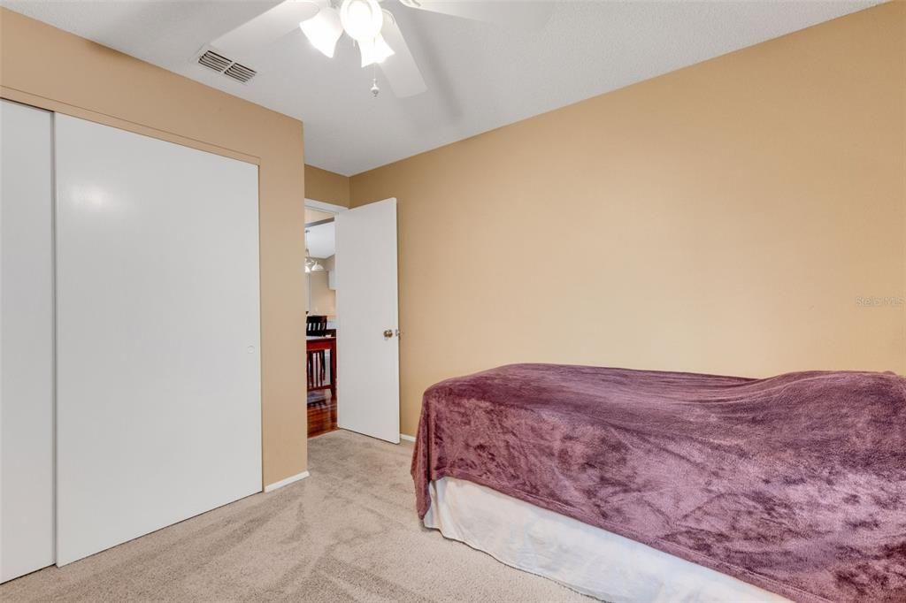 third bedroom showing door to hallway near dining room