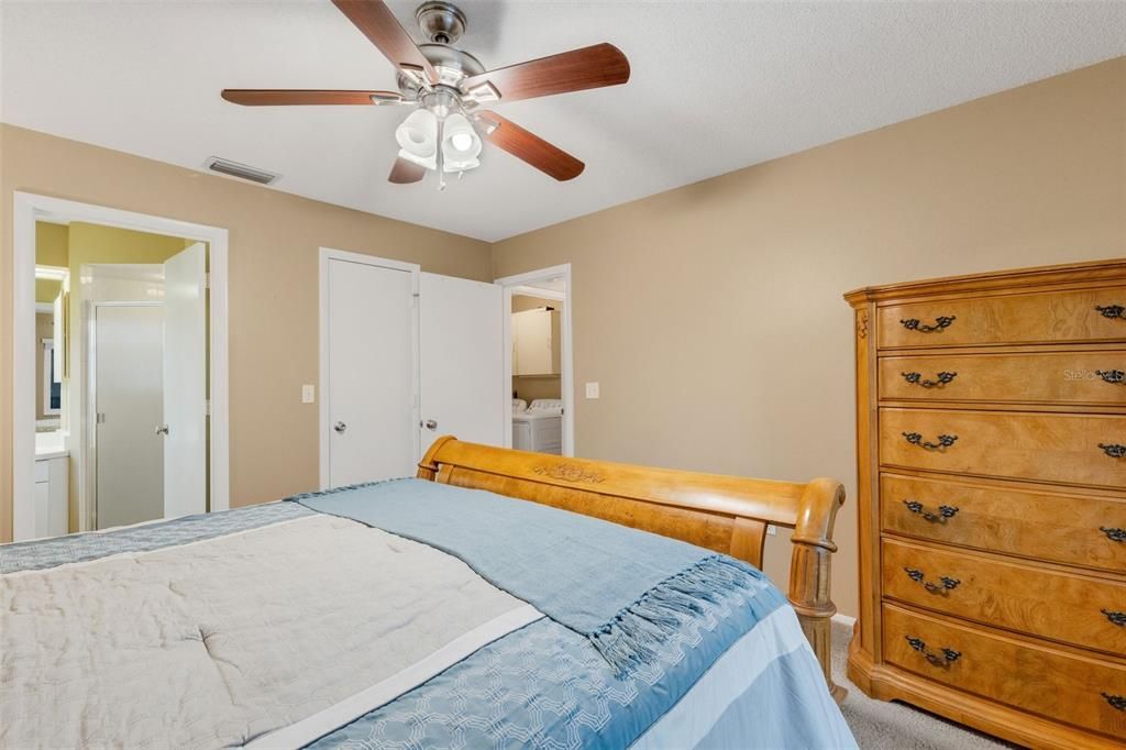 another view of the primary bedroom showing the hall/laundry room