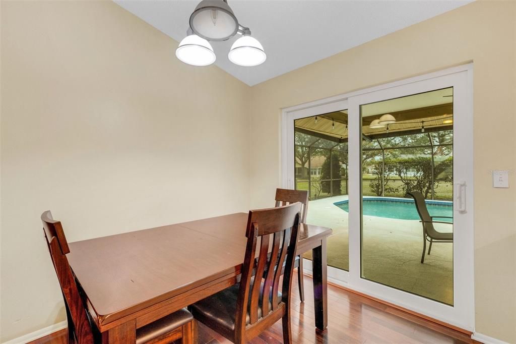 dining room with impact slider to the patio/pool area