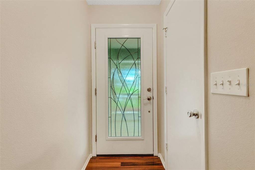 looking back to beautiful glass impact door and coat closet