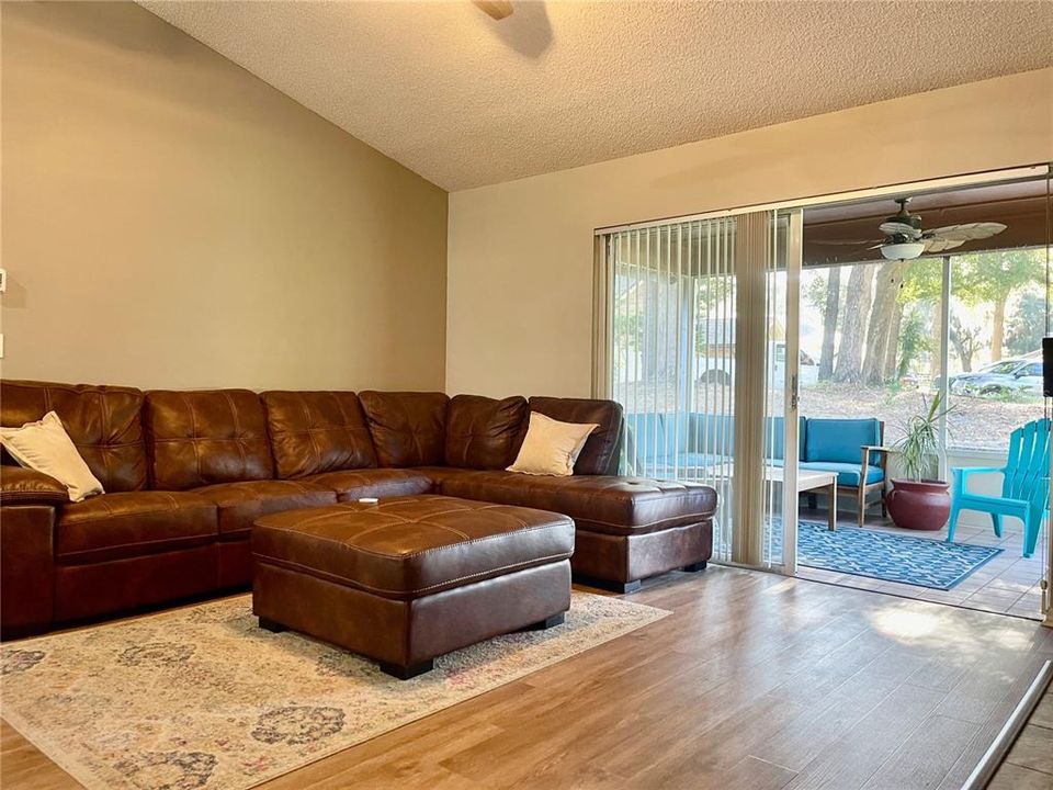 Cozy Family room with fireplace and access to screened patio and backyard entertaining area