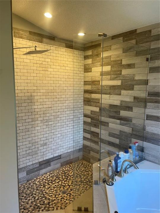 classic frameless glass shower with custom designed tile