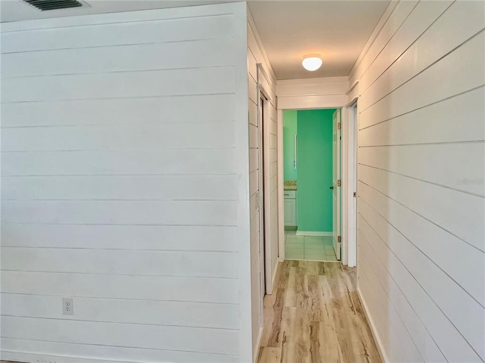 Hallway from the Primary bedroom hall toward the bathroom and walk-in closet