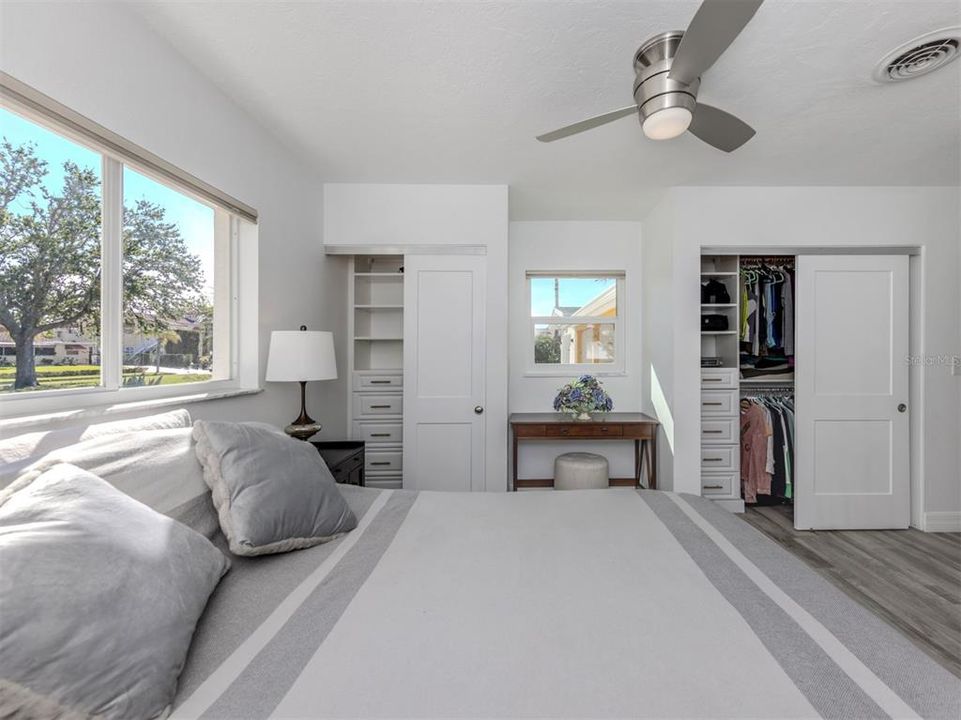 Primary bedroom with dual custom designed closets and vanity.