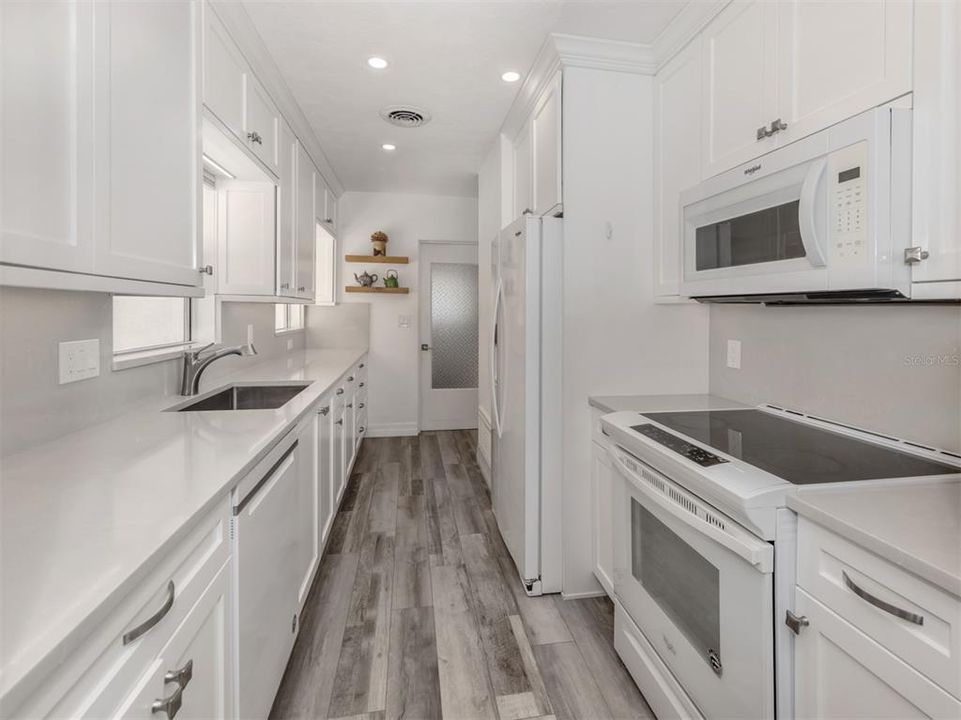 Modern luxury kitchen with quartzite counters and backsplash