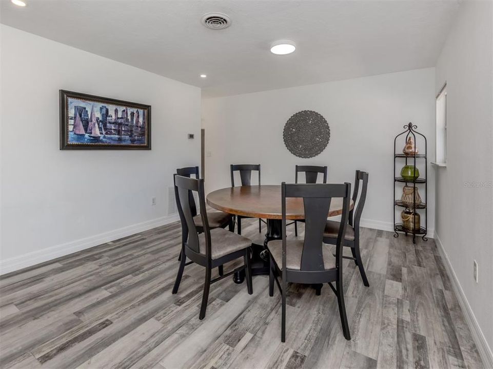 Dining room table and artwork fit beautifully in the dining room.