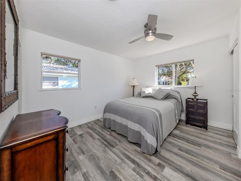 Primary bedroom has privacy Levolor cellular shades in a neutral tone