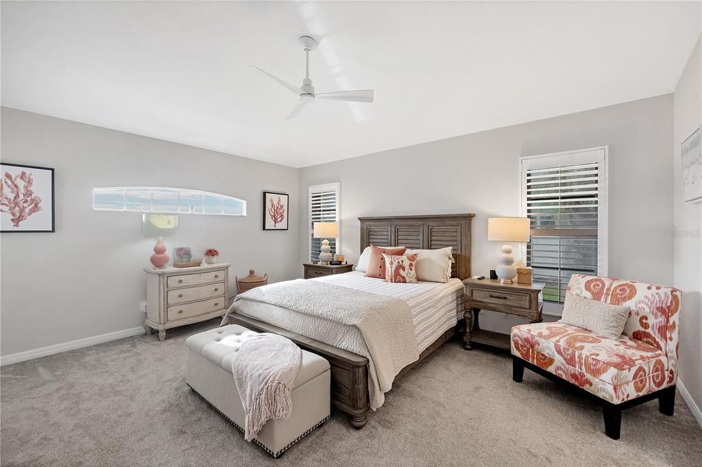 The large master suite has plantation shutters  and plenty of room for a sitting area