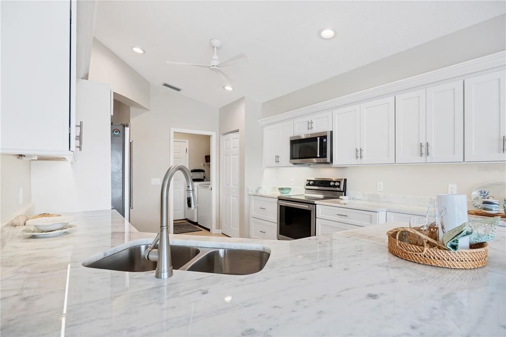 New Kitchen with white shaker wood cabinets.  Pull outs and soft close and dolomite countertop along with fresh paint