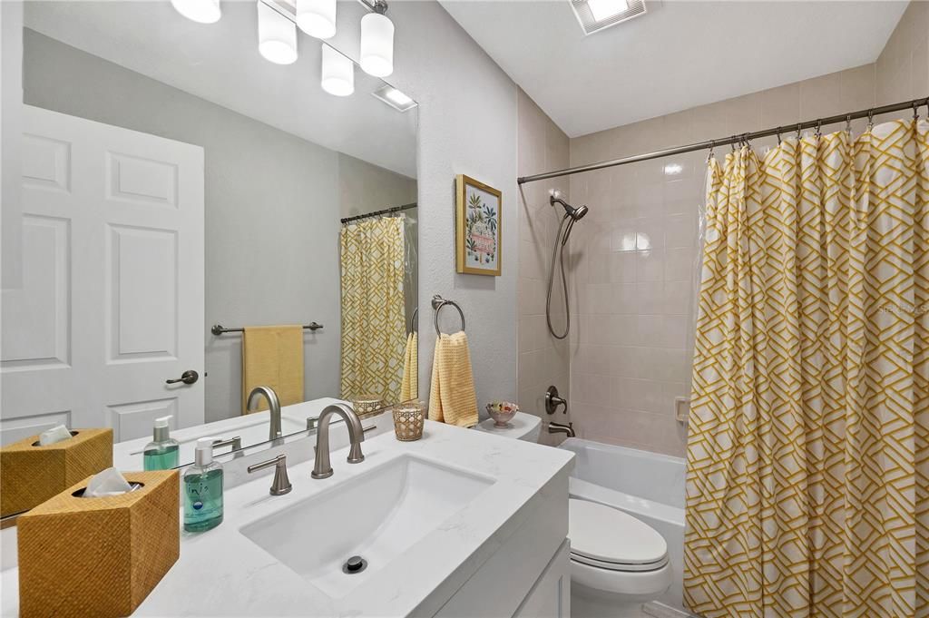 Newly renovated bath with new sink, counter, vanity, toilet and tub liner