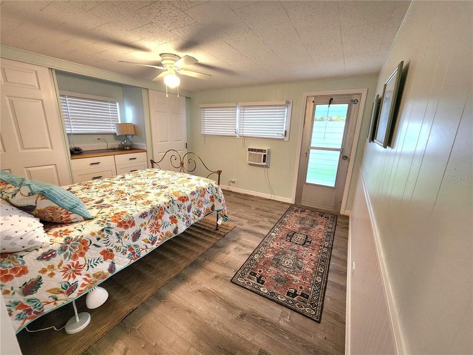 2nd bedroom has an exterior access.  2 closets and a ceiling fan. All new flooring and some wainscoating on the right wall