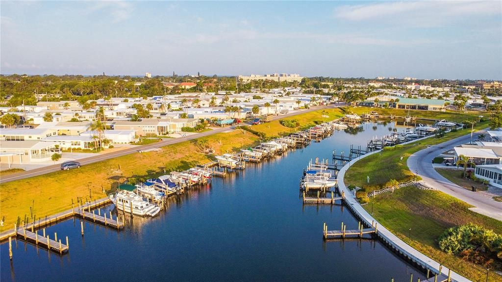 view of the park and private harbor.  The clubhouse is the green roof at the end. You can view the harbor from the fitness center and outside patio at the clubhouse.