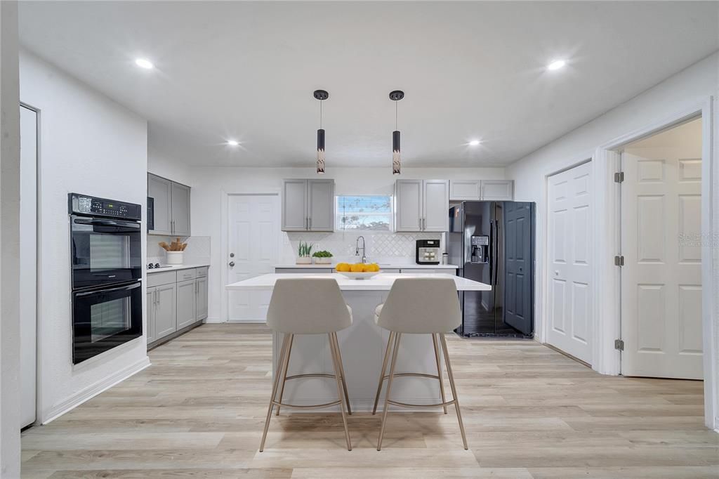 Virtually staged. Kitchen Space and Laundry Room by the fridge