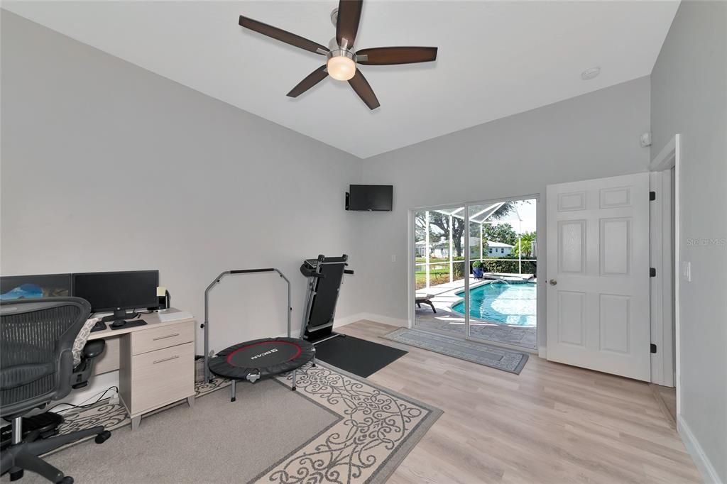 Fourth bedroom nestled back in its own private suite with sliding glass door to pool